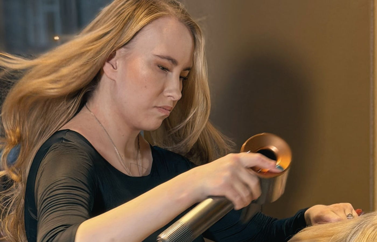A hair professional at work in the serene Niki Newd Studio hair lounge in Helsinki.