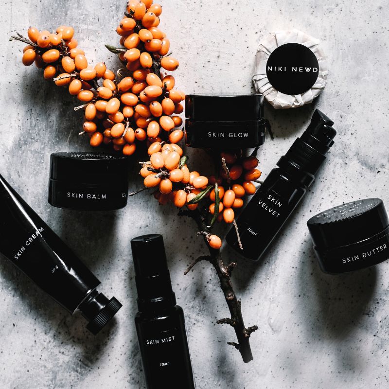 Niki Newd sustainable skincare products in biophotonic glass bottles with recyclable packaging — designed to protect natural active compounds while eliminating unnecessary materials.