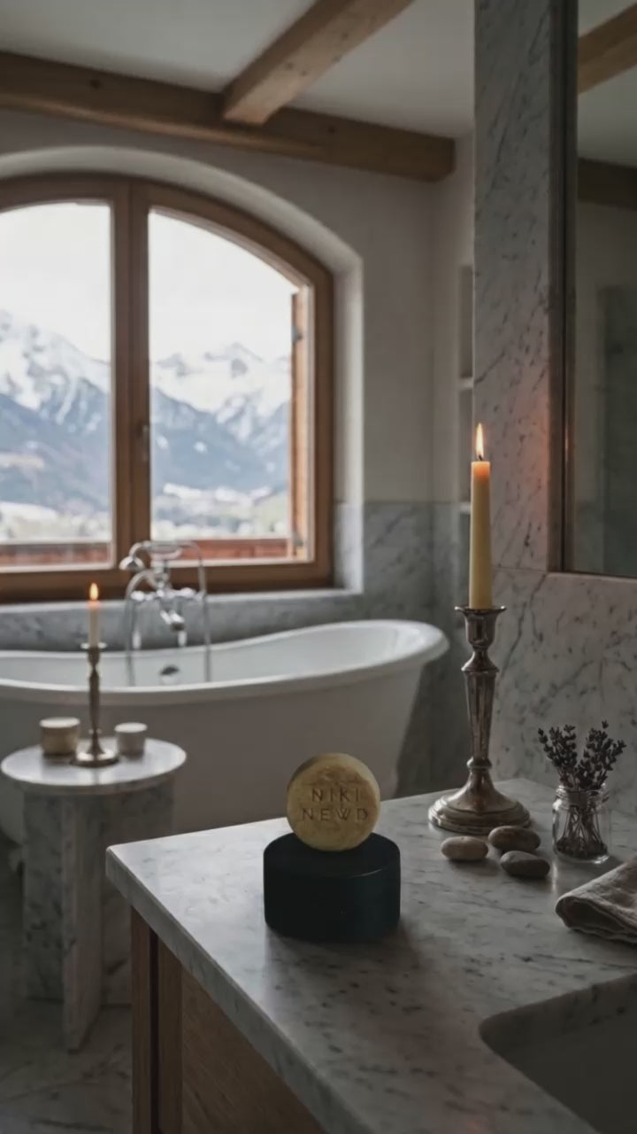 Niki Newd Oatmeal Soap and soap case at a hotel – effortlessly luxurious facial cleansing for travel.