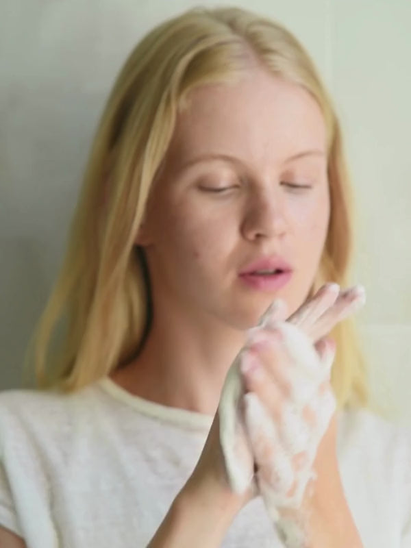 Model Rosa Majava demonstrating Niki Newd Oatmeal Soap rich creamy lather — nourishing handmade natural artisan soap for sensitive skin.
